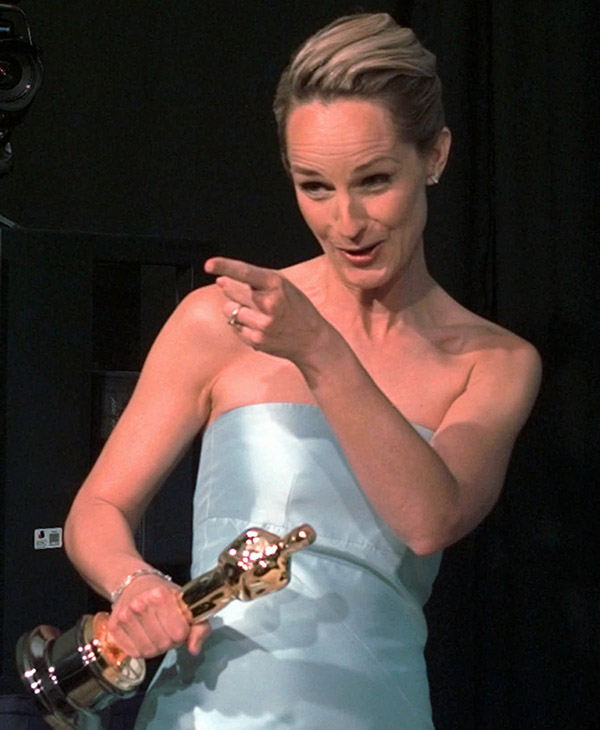 Helen Hunt points to photographers as she enters a media room backstage at the 70th Academy Awards at the Shrine Auditorium in Los Angeles Monday, March 23, 1998.